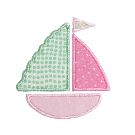 close up of Deacon Lane's pink sailboat applique in pinks, green, cream, and white