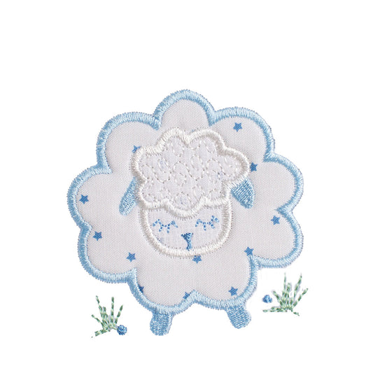 Close up of blue fluffy sheep applique with a cream with blue star fabric