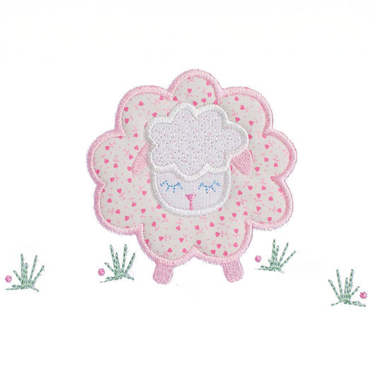 close-up of a hand made applique of a pink floral sheep with darling pink ears and feet