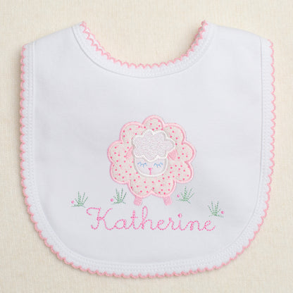 charming hand made appliqued bib with a pink floral sheep with a personalized name embroidered amongst the flowers