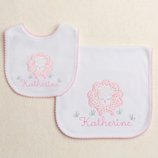 Baby gift set of 2 picot trimmed pieces - a burp pad and a bib.  Features a pink floral sheep applique with a personalized embroidered name
