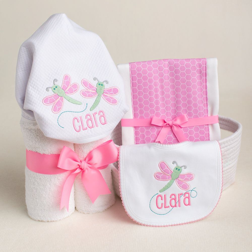 Baby boutique luxury gift of an appliqued hooded towel, a fabric burp pad and a personalized appliqued bib.  Name of the child is integrated into the design in a unique and special way