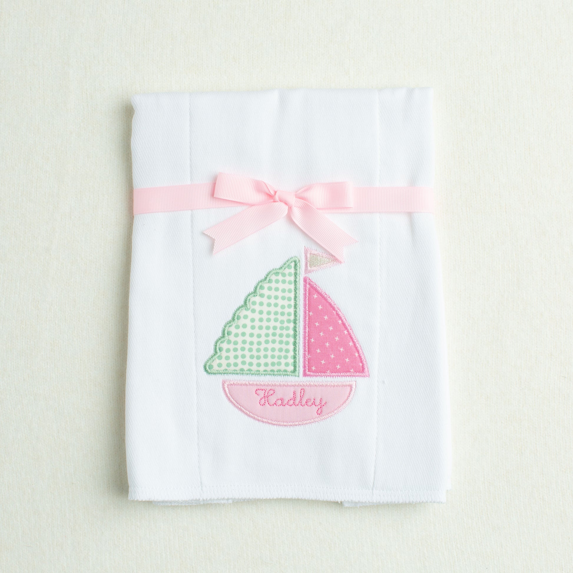 white burp cloth with Deacon Lane's Pink Sailboat Applique in pink, green, white, and cream