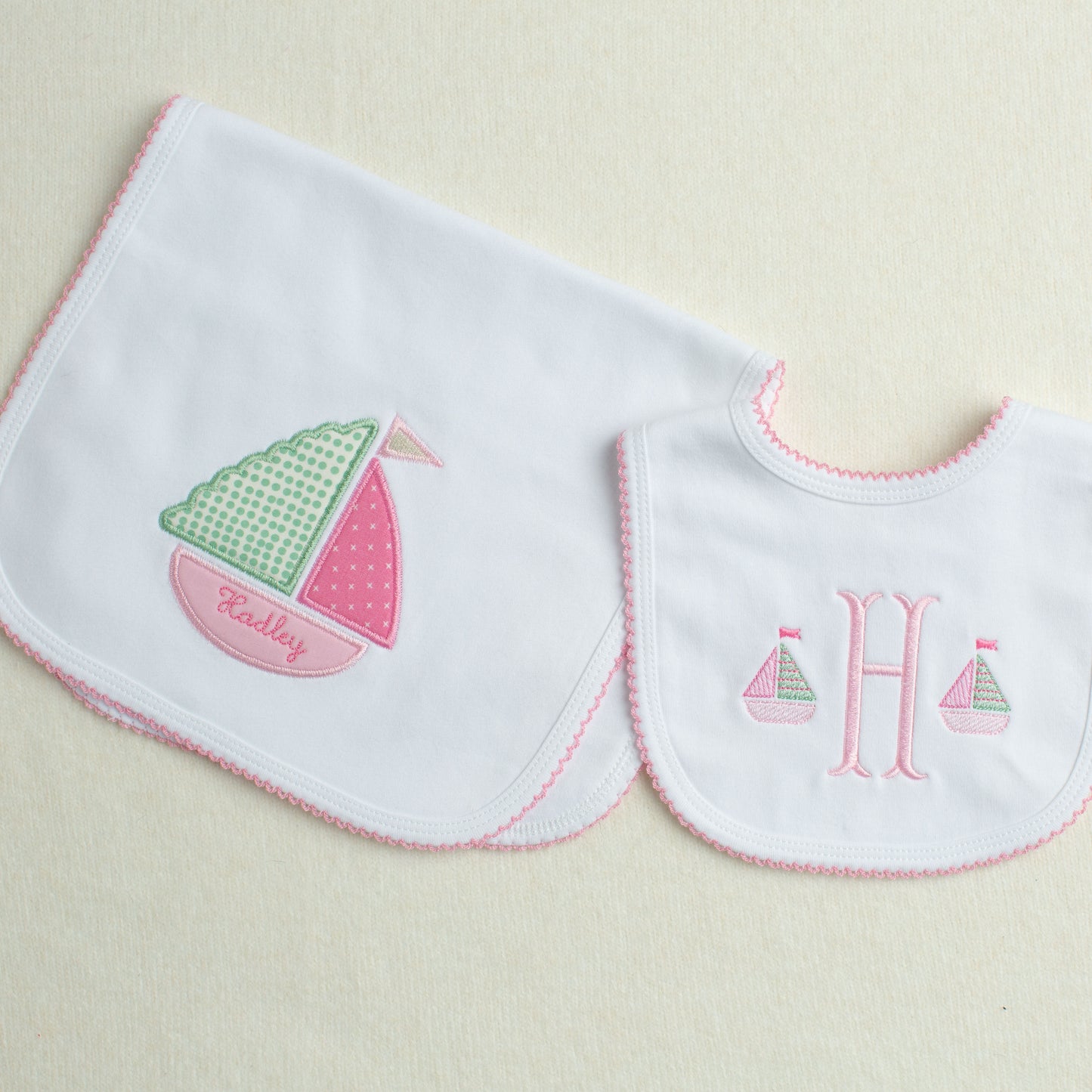2 piece baby gift set with a nautical theme in shades of pink, green, white and cream.

