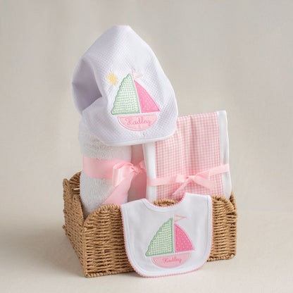 3 piece charming baby boutique gift set including a towel, a fabric burp pad and a bib.  The towel and the bib feature Deacon Lane's exclusive sailboat motif and include a cleverly customization idea as the child name is included in the bottom of the boat.
