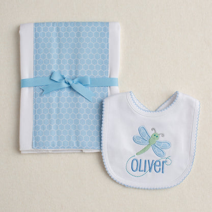 Two piece boutique baby gift set with a blue hex fabric burp pad and a bib with a dragonfly hand made applique with a custom name embroidered on it.