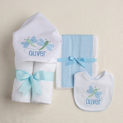 3 piece gift set with a hooded towel, fabric burp pad and a picot bib.  All pieces work together as part of Deacon Lane's exclusive dragonfly group featuring a green and baby blue dragonfly.  The bib is customized with the child's name embroidered on it.