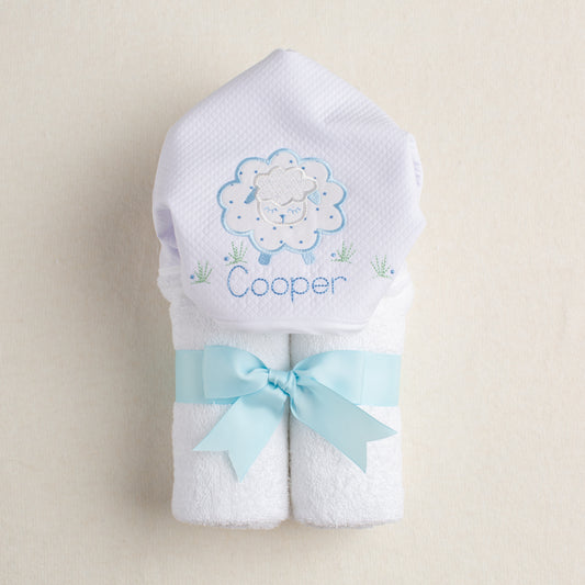 White hooded towel with embroidered sheep design and personalized with an embroidered name.