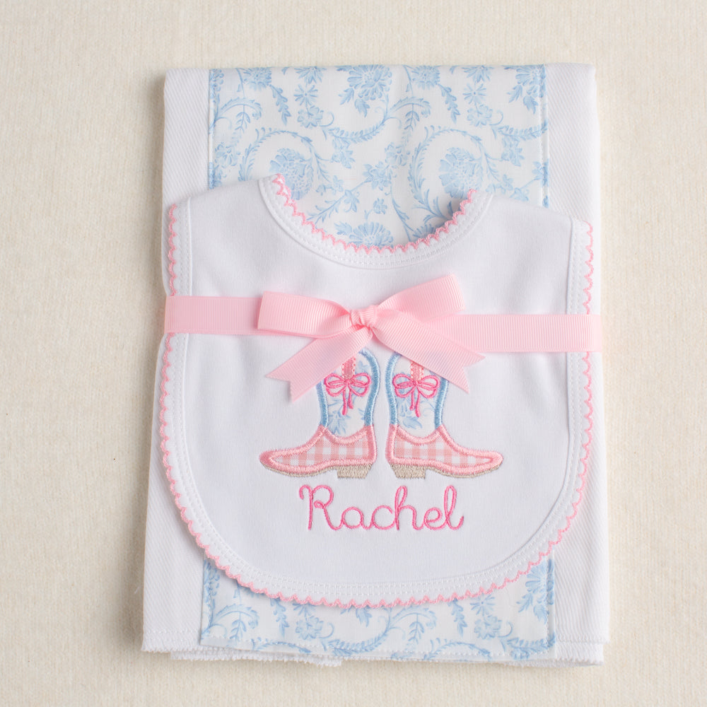 2 piece set tied attractively with a pink grosgrain bow to match the western theme pink and blue cowgirl boots on the picot bib.  Personalized with a name in an embroidered child-like script.