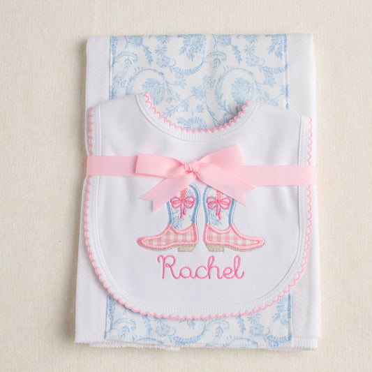2 piece set tied attractively with a pink grosgrain bow to match the western theme pink and blue cowgirl boots on the picot bib.  Personalized with a name in an embroidered child-like script.