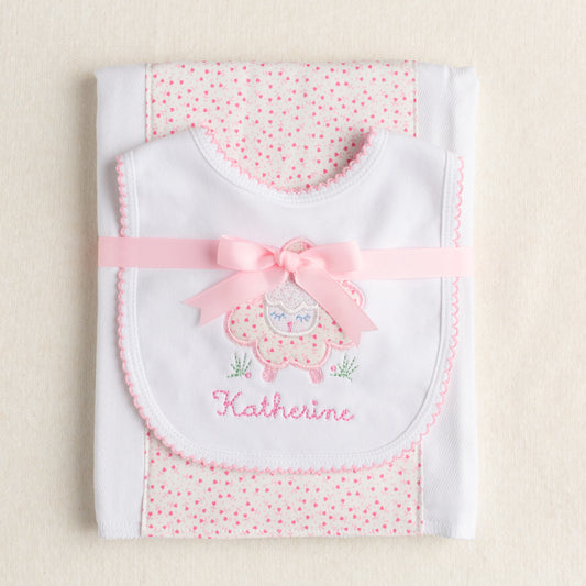 Boutique baby gift set with hand made burp cloth with delightful fabric panel down the middle and an appliqued pink floral sheep on a cotton bit with a picot edge