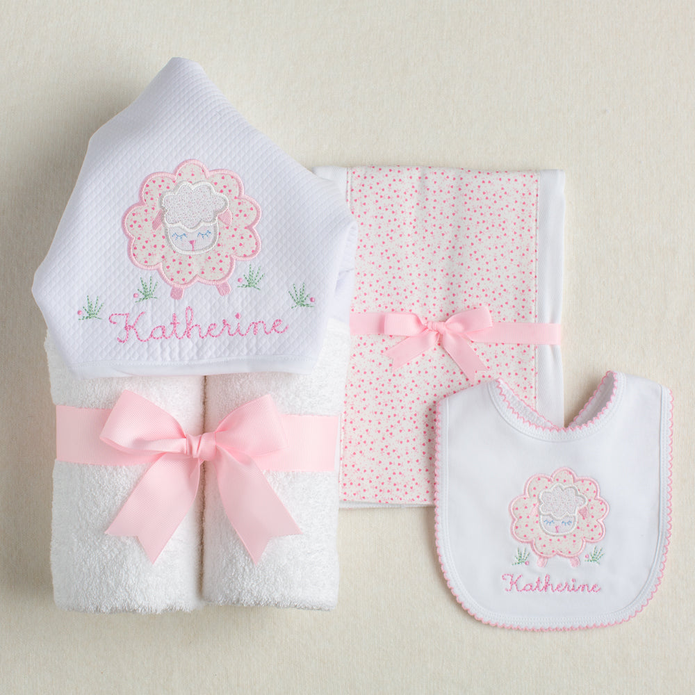 Deacon Lane exclusive gift set with appliqued hooded towel, fabric burp pad and bib in a pink floral sheep motif