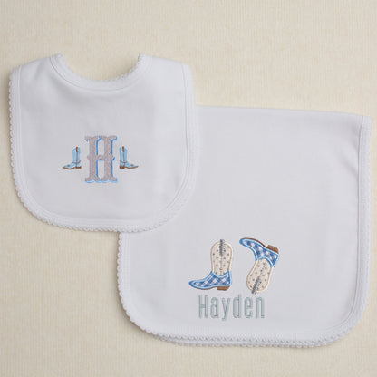 2 piece Western themed gift set with a burp pad with appliqued cowboy boots and a bib with a western shadow two tone font.
