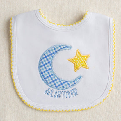 Baby boutique white knit cotton bib with picot trim and a hand made applique in a moon and star motif with a personalized name.