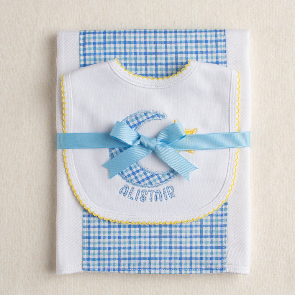 Personalized baby boutique gift set with a fabric burp pad and a hand appliqued bib with a moon and star motif personalized with a name for a one of a kind gift.