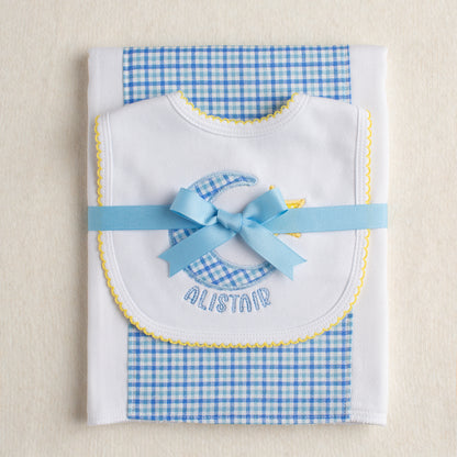 Personalized baby boutique gift set with a fabric burp pad and a hand appliqued bib with a moon and star motif personalized with a name for a one of a kind gift.