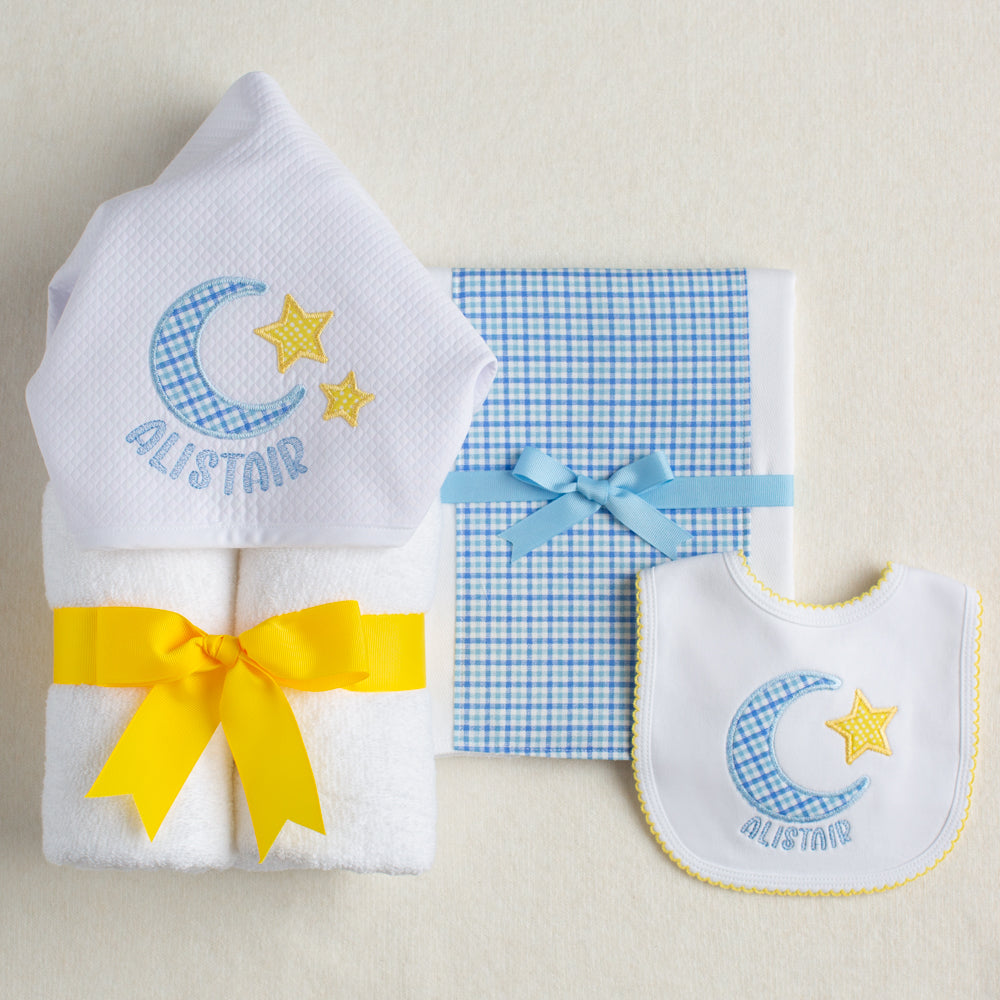 3 piece boutique baby gift set with an appliqued hooded towel, a fabric burp pad, and an appliqued cotton knit bib with a moon and star motif.  Personalized with a name.