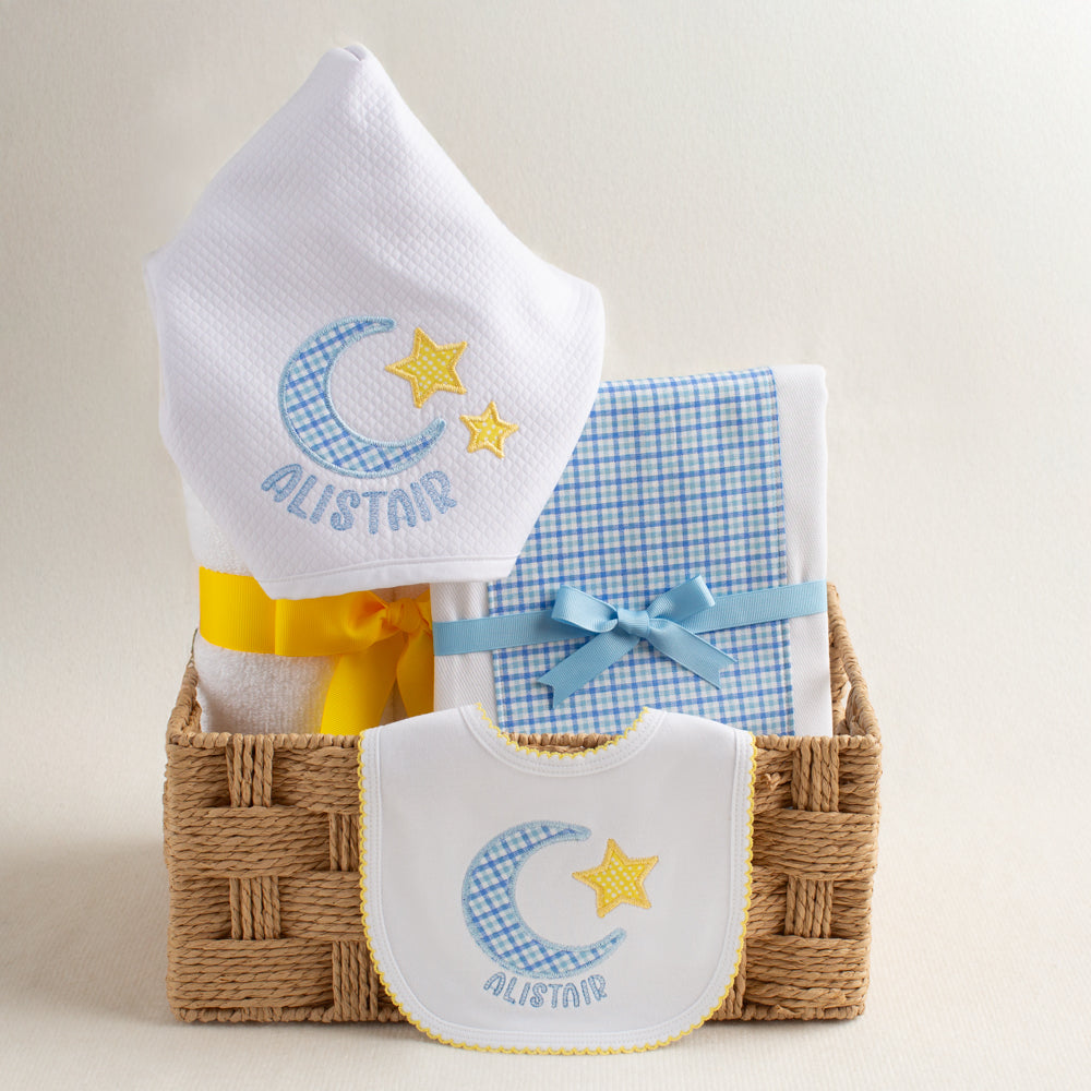 Premier baby boutique gift set of 3 items including an appliqued hooded towel, a fabric burp cloth made from a cotton diaper, and a white cotton knit bib appliqued with a moon and star motif.