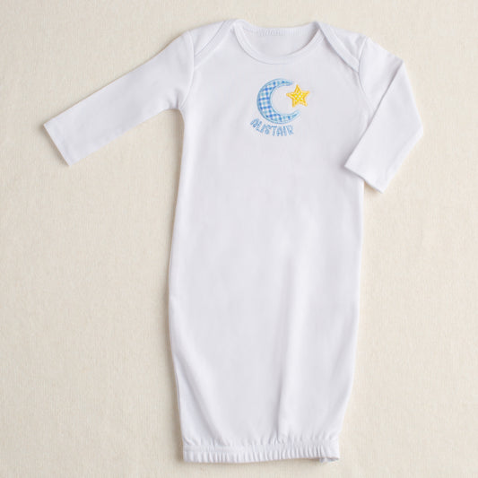 White baby gown with a zipper closure at the bottom and a hand applique moon and star motif and a personalized name
