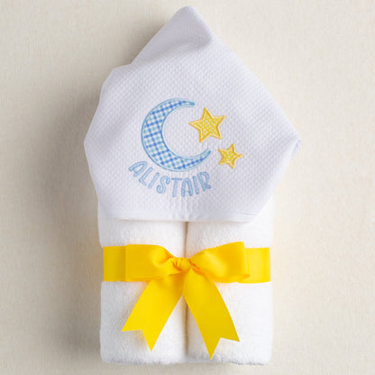 White hooded towel with a hooded hand appliqued with a moon and star motif and personalized with a name.