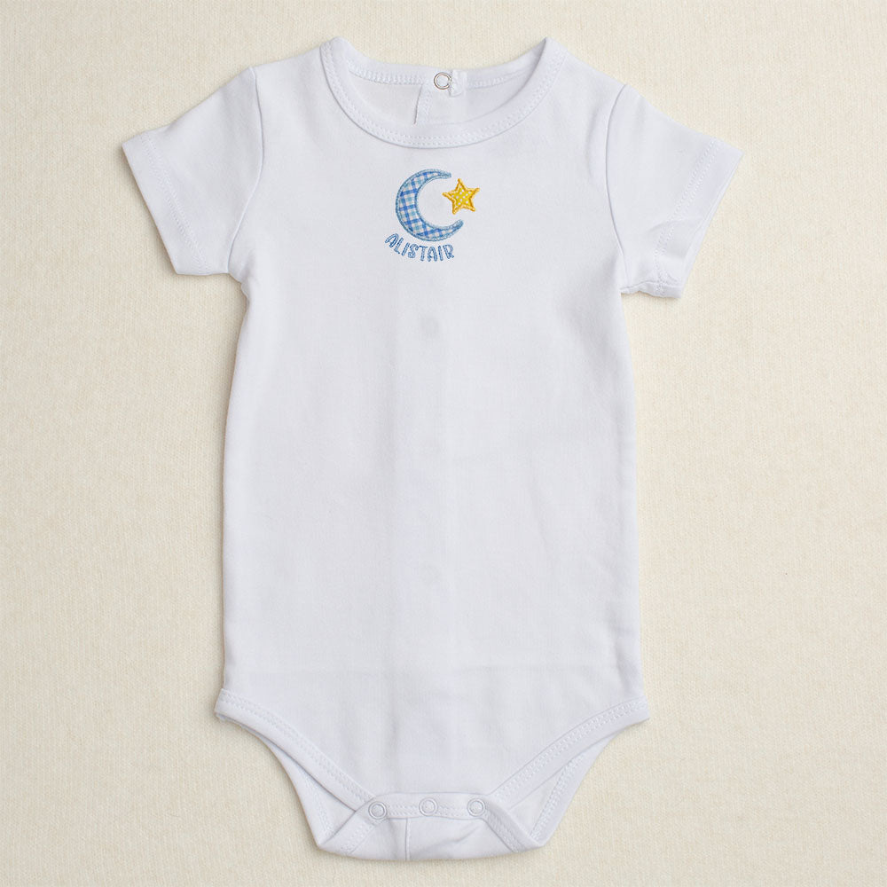 White baby bodysuit/onesie with Deacon Lane's exclusive Bella Notte moon and star applique design.