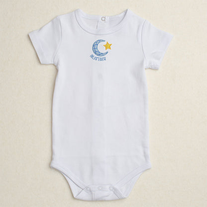 White baby bodysuit/onesie with Deacon Lane's exclusive Bella Notte moon and star applique design.