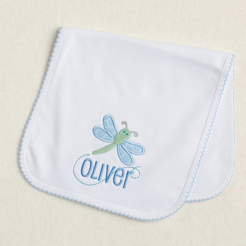 Picot trimmed white burp pad with green and blue dragonfly applique and embroidered name