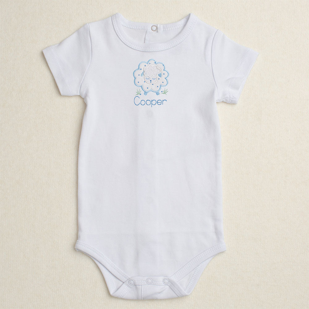 All cotton bodysuit with short sleeves and a blue sheep applique that can be personalized with embroidery