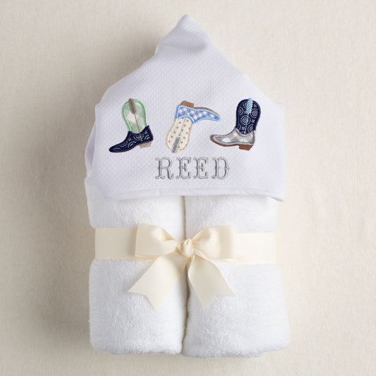 Photo showing product and detail of handmade cowboy boots design on hooded baby and toddler towel.