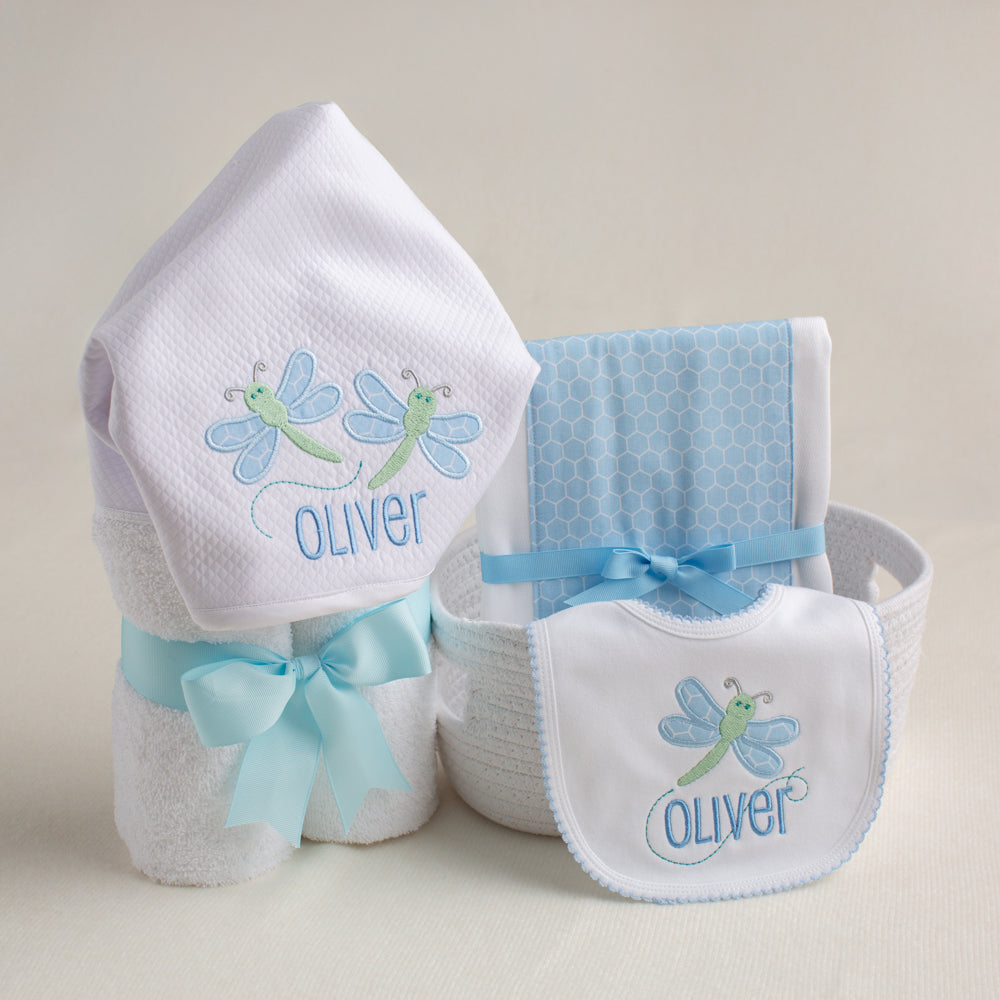 3 Piece gift set with  hooded towel, bib, and fabric burp pad in a blue and green Deacon Lane dragonfly applique motif.
