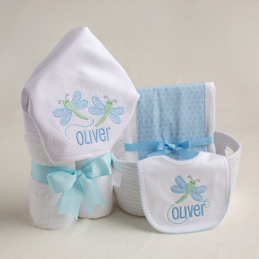 3 Piece gift set with  hooded towel, bib, and fabric burp pad in a blue and green Deacon Lane dragonfly applique motif.