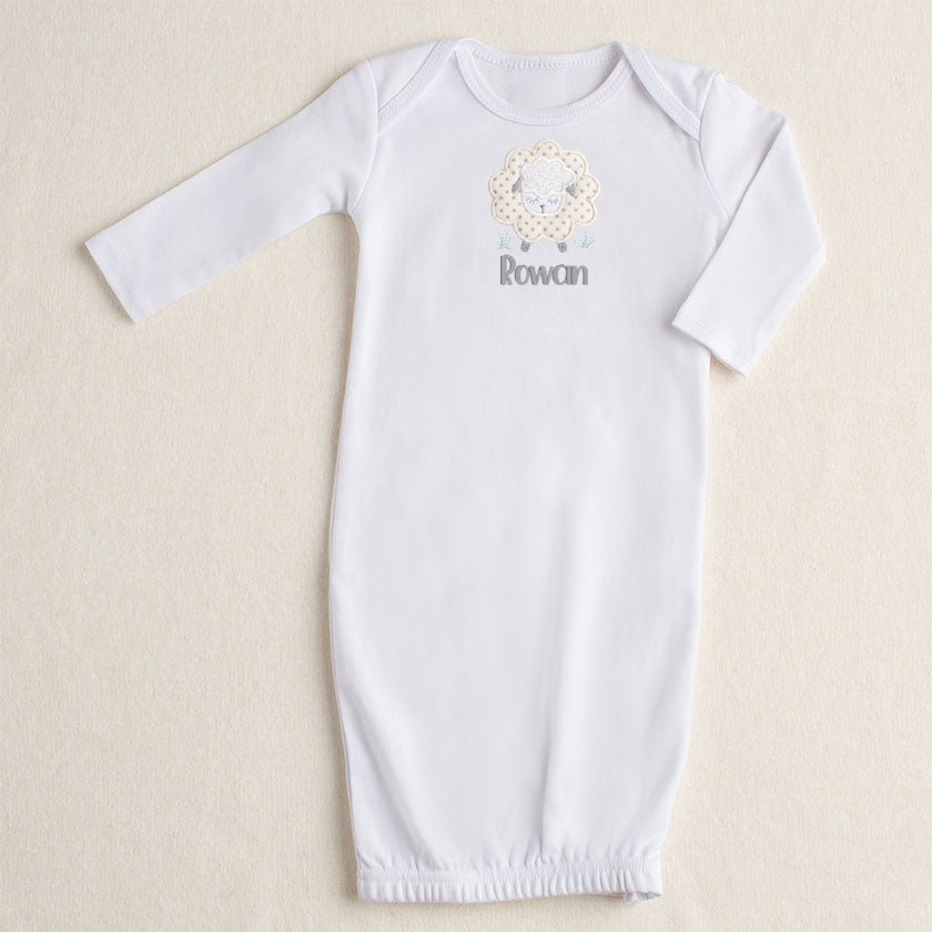 White NB-3M gown with a zippered bottom opening.  Featuring Deacon Lane's gender neutral Grey Fluffy Sheep applique in cream, white, and grey.