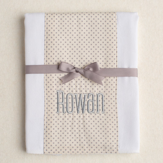 white all cotton burp pad made from a cloth diaper with a personalized name embroidery ready for gift giving tied with a grosgrain ribbon