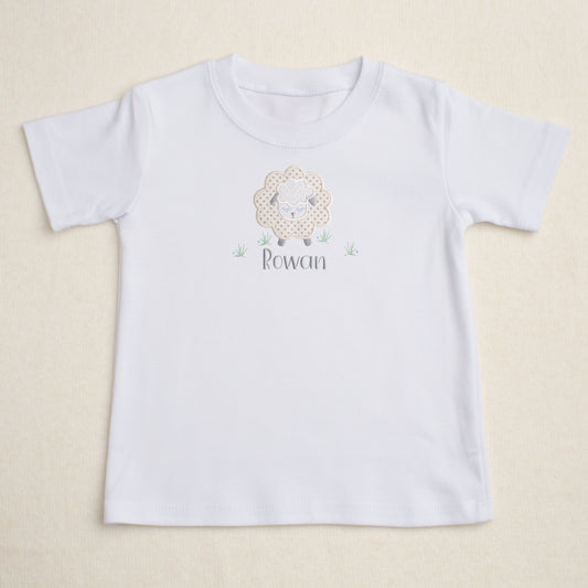 white t-shirt with Deacon Lane's Grey Fluffy Sheep applique in grey, cream, and white