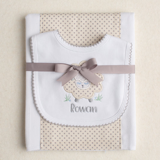 Personalized boutique Baby gift set with a fabric burp pad a bib with a grey sheep applique and a personalized embroidered name.