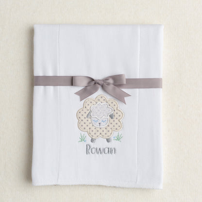 white burp pad made from a 100% cotton diaper with a gender neutral grey star sheep applique with a personalized embroidered name