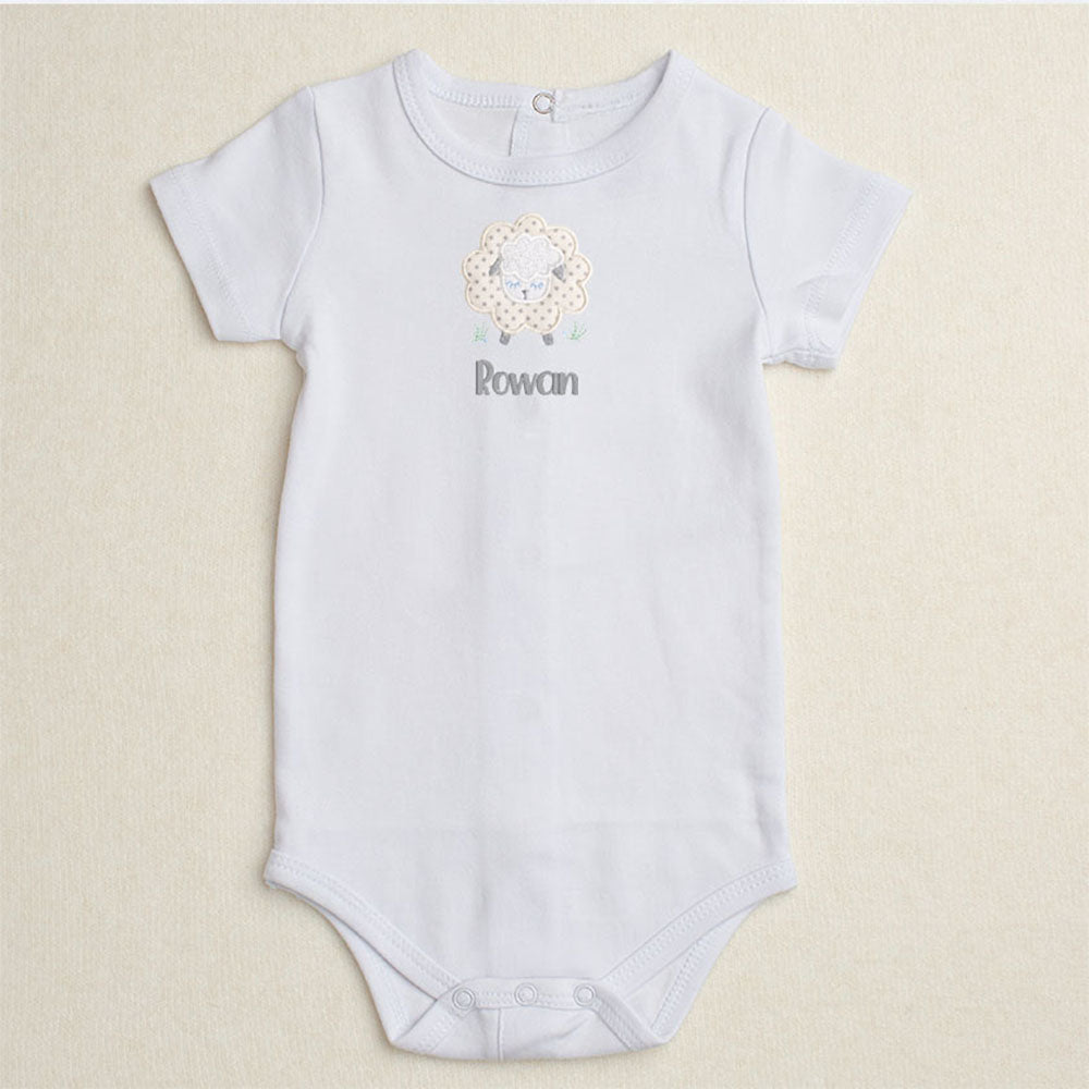 White bodysuit/onesie featuring Deacon Lane's Grey Fluffy Sheep applique in grey, cream, and white.