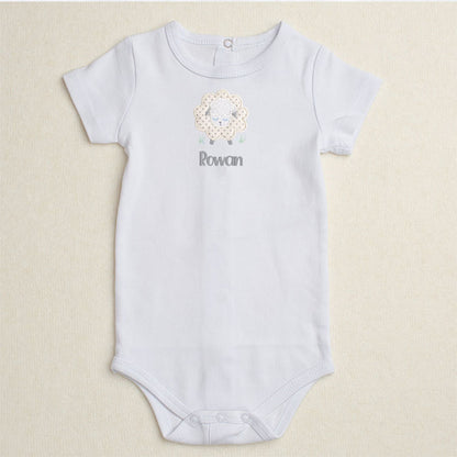 White bodysuit/onesie featuring Deacon Lane's Grey Fluffy Sheep applique in grey, cream, and white.