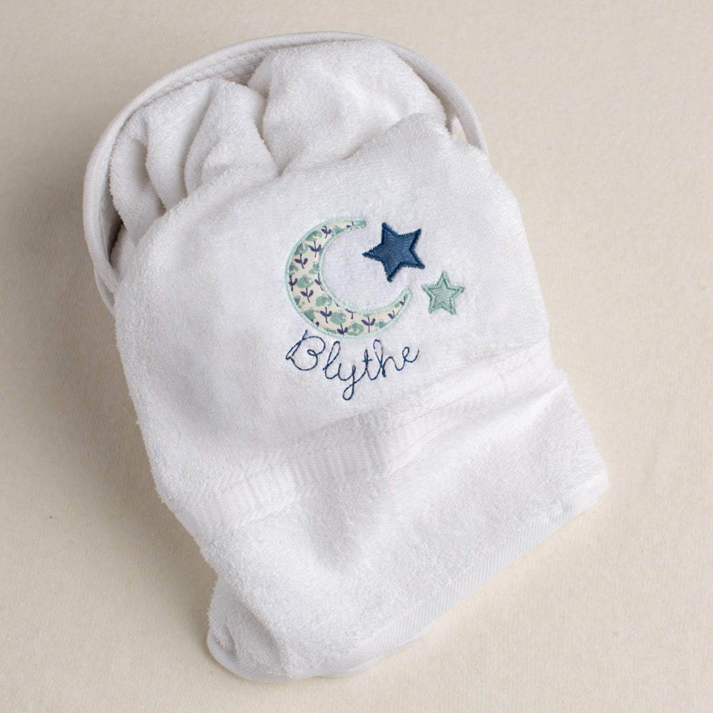 white cotton bath towel personalized for your child with a lovely moon and star motif in seafoam and navy with a custom name embroidery.