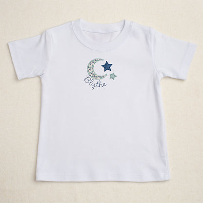 white t-shirt with Deacon Lane's exclusive moon and star applique design from their Bella Notte collection.  Perfect for big sister to match younger siblings with a handmade gift.