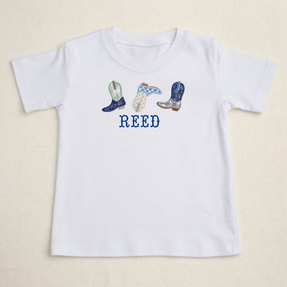 White t=shirt with appliqued cowboy boots and a personalized embroidered name