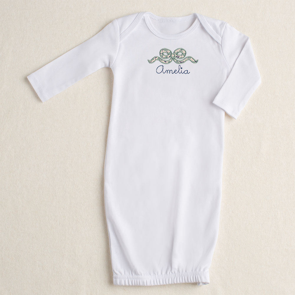 white baby gown with navy floral applique bow and personalize name