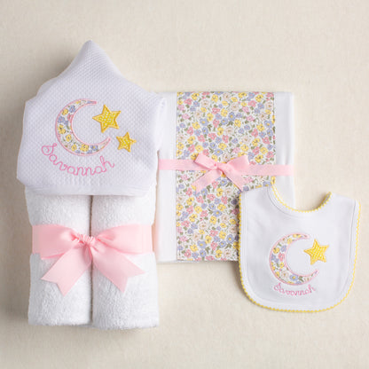 Baby gift set with hooded towel, fabric burp pad and bib all with a pink Liberty like floral motif for personalized boutique baby gift giving