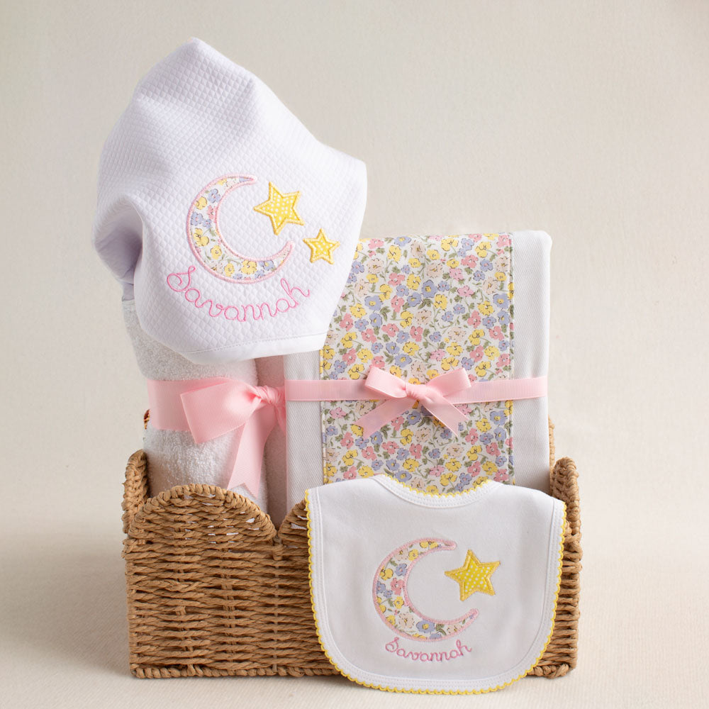  A Liberty of London inspired boutique baby gift set with a hooded towel, burp pad and bib all with a hand-done appliqued moon and star motif.