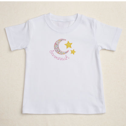 Premium white t-shirt with a darling handmade applique out of a fabric reminiscent of a Liberty of London floral print in a moon and star motif.