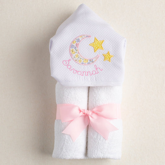 White hooded towel with personalized hood and hand appliqued moon and star motif.  Towel features a pink floral print that is reminiscent of a Liberty of London floral fabric.