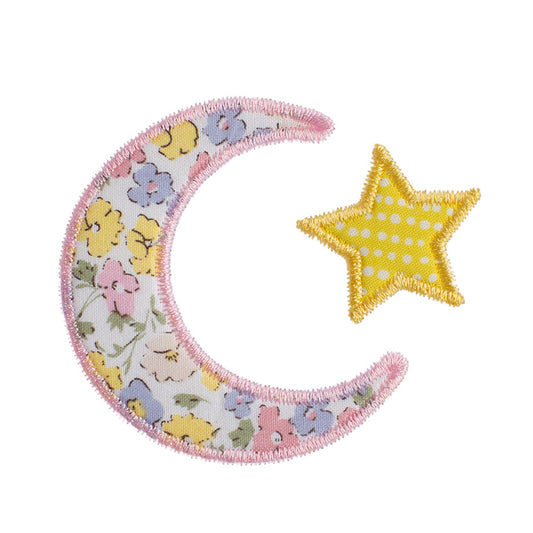 Close up of Deacon Lane's moon and star motif made from a pink floral fabric reminiscent of a Liberty of London fabric print.