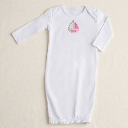 White cotton baby gown product shot with Deacon Lane signature pink sailboat applique in shades of pink and green with a personalized embroidered name in the bottom of the boat - unique.
