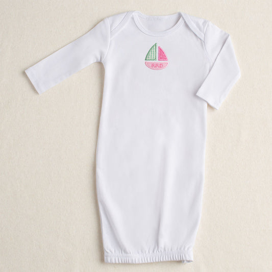 White cotton baby gown product shot with Deacon Lane signature pink sailboat applique in shades of pink and green with a personalized embroidered name in the bottom of the boat - unique.
