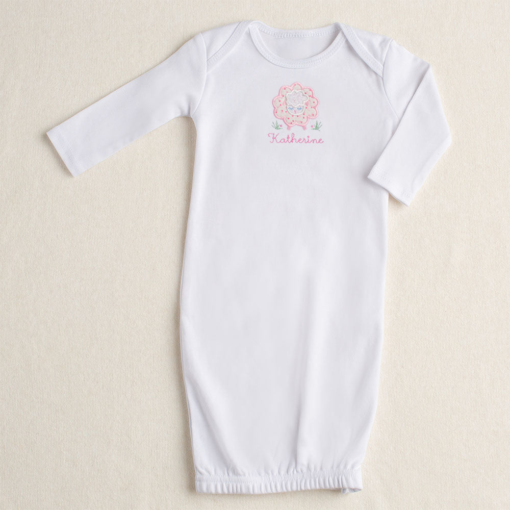 white cotton newborn baby gown with hand made pink floral sheep applique with convenient zipper opening at the bottom
